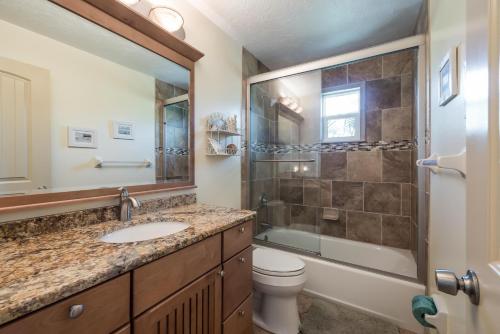 a bathroom with a sink and a toilet and a shower at Seabreeze A in Holmes Beach