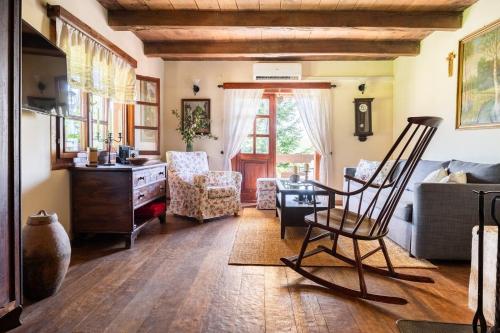a living room with a chair and a desk at Oazena , Authentic house in peaceful village in Selnica