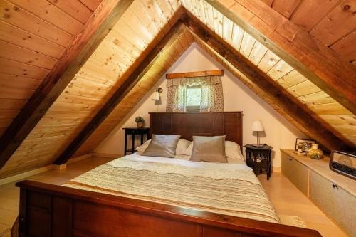a bedroom with a bed in an attic at Oazena , Authentic house in peaceful village in Selnica