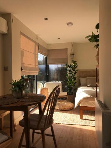 a living room with a table and a bed at Your Dublin Basecamp in Dublin