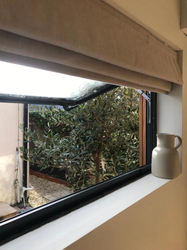a window with a vase sitting on a window sill at Your Dublin Basecamp in Dublin