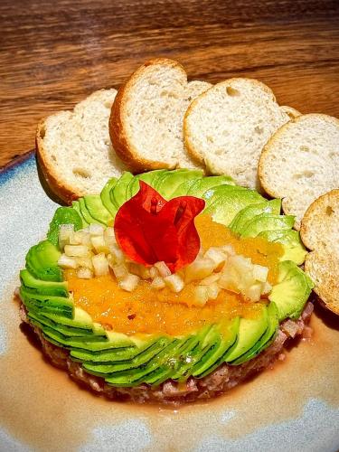 a sandwich on a plate with two slices of bread at Izotal Bioluxury Hotel in Taminango