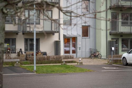 a white car parked in front of a building at Guestly Homes - Elite Studio Apartment in Nyköping