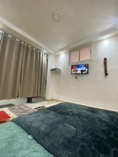 a living room with a large rug on the floor at la poste in Imouzzer Kandar