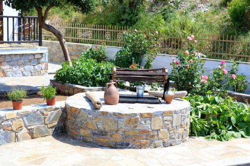 a bench sitting on top of a stone fountain at Maria Studios in Neo Klima