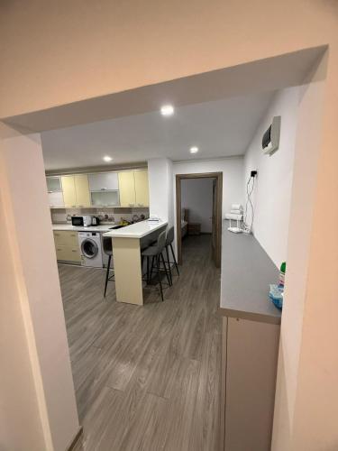 a kitchen and living room with a table and chairs at La Maria in Comăneşti
