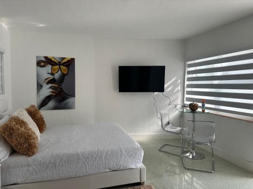 a bedroom with a bed and a flat screen tv at Villa Clara VIP-Little Havana in Miami