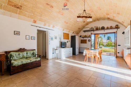a living room with a couch and a table at Villa Alida by Vivimy in Andrano