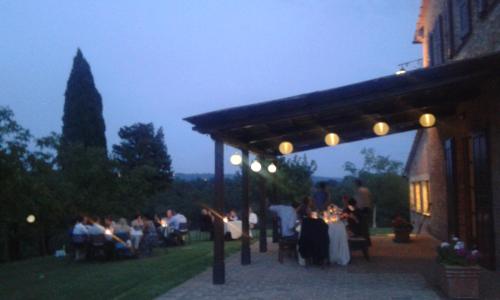 a group of people sitting under a pavilion at a wedding at Agriturismo Chieteno con piscina e AC- Cetona in Cetona