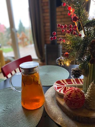 a jar of honey on a table with a christmas tree at Czereśniowe Wzgórze Sandomierz jakuzzi in Sandomierz
