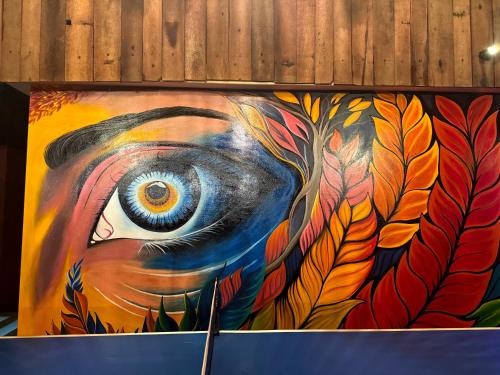 a painting of an eye on a wall at Casa Branca Retreat in Varkala