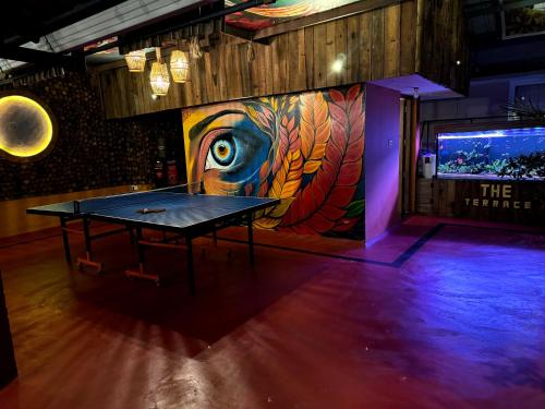 a ping pong table in a room with a mural at Casa Branca Retreat in Varkala