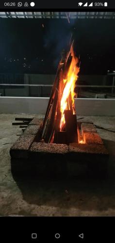 a fire is burning in a fire pit at night at M3 Homes in Munnar