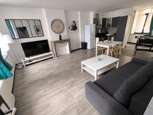 a living room with a couch and a table at Logis de la forteresse in Sedan