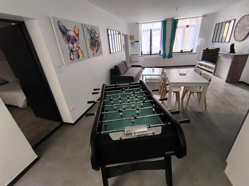 a living room with a pool table in the middle at Logis de la forteresse in Sedan