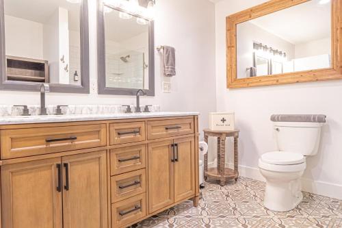 a bathroom with a toilet and a sink and a mirror at Lakefront Lookout- 14 S in Fort Ann