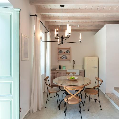 a dining room with a table and chairs at Nisomar Suites in Symi