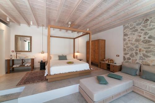 a bedroom with a large bed and a couch at Nisomar Suites in Symi