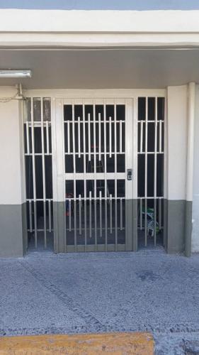 a building with a gate in front of it at Departamento sencillo LM in Los Mochis