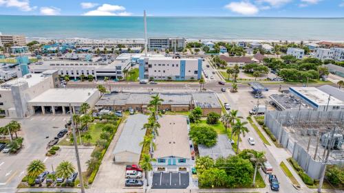 an aerial view of a city with the ocean at The Shark Tank Cocoa Beach - Retro Florida, Downtown, 5-Min Walk to Beach, Shops & Bars in Cocoa Beach