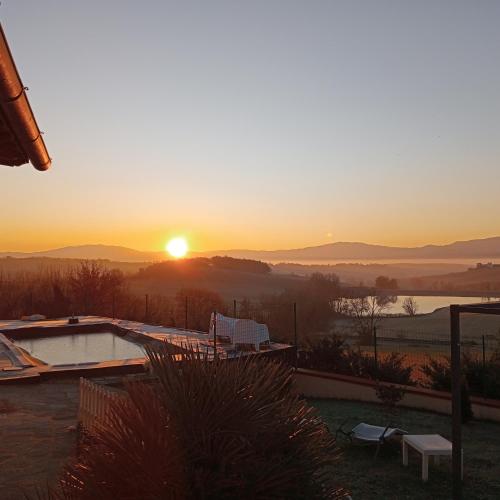 a sunset from the patio of a house with a swimming pool at Il Marrondindo Bed & Breakfast in Galliano