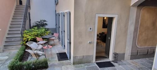 a balcony of a house with a table and chairs at THERESA DELUXE Italia in Cannobio