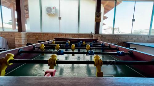 a row of pool tables in a room at Casa espaçosa com sala de jogos interna e externa in Florianópolis