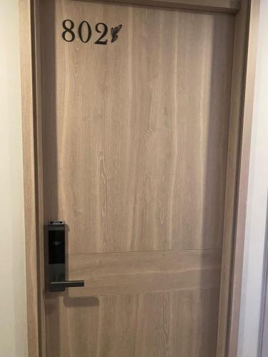a wooden door with a sign on it at Hotel Living 35 Suites Piso 8 Vip in Medellín
