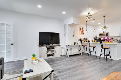 a living room with a kitchen and a living room with a table at Philly Hub Near World Cup and Downtown Attractions! in Philadelphia