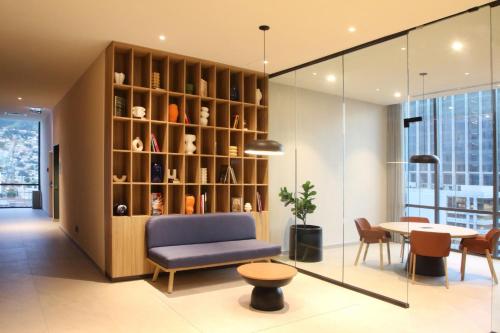 a living room with a chair and a table at City Express Plus by Marriott Monterrey Centro in Monterrey