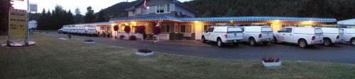 a group of vehicles parked in front of a house at Evening Star Motel in Greenwood