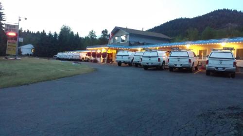 a row of white trucks parked in front of a building at Evening Star Motel in Greenwood
