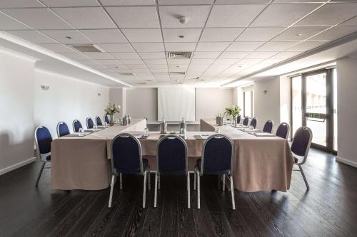 a conference room with a long table and chairs at Radisson Blu Resort, Malta St. Julian's in St Julian's