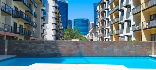 a swimming pool in front of some buildings at Resort-style living in Perth CBD - 2X2 Apt in Perth