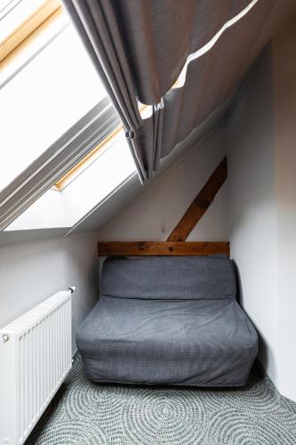 a bed in a room with two windows at Dwór Kolesin in Nowe Kramsko