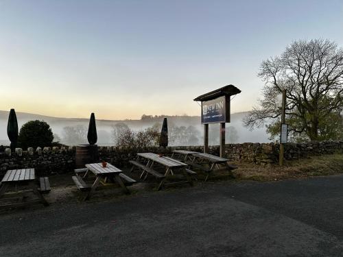 a group of picnic tables on the side of a road at New Inn Appletreewick in Appletreewick