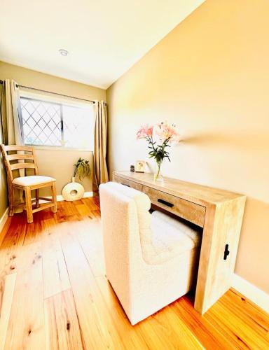 a living room with a desk and a chair at Oceanside Manor - Fancy Room - Golf course & Beach View in Qualicum Beach