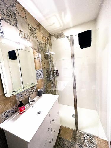 a bathroom with a shower and a sink at Casa Helena in Tavira