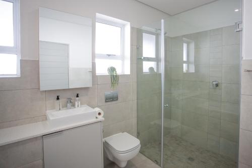 a bathroom with a toilet and a sink and a shower at Townhouse 50 - 1 On York in George