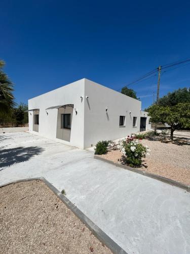 a white house with a driveway in front of it at Casa Helena in Tavira