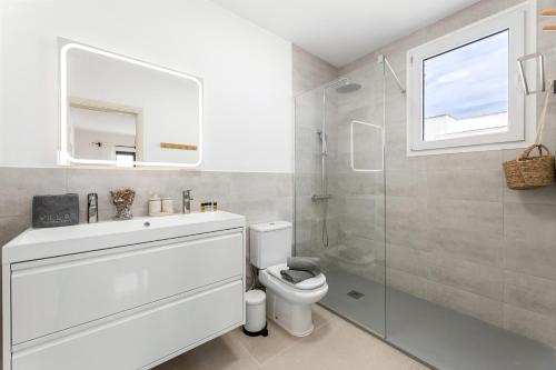 a white bathroom with a toilet and a shower at Villa 3 VipVipVillas in Tías