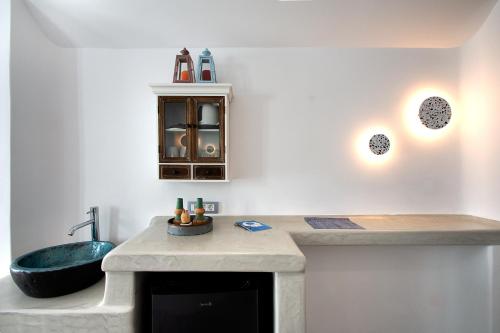 a bathroom with a sink and a bath tub at Aegean Blue Suites in Pirgos