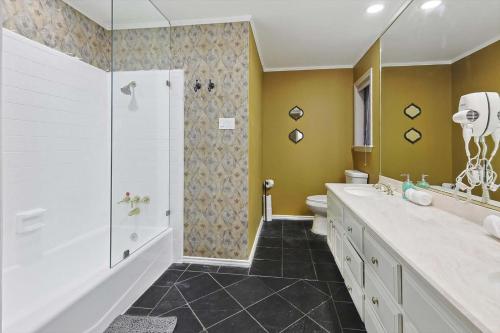 a bathroom with a shower and a sink and a toilet at Beautiful 5BR 2BA DeSoto Holiday Home with Pool in DeSoto