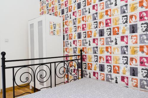 a wall covered in photos of people at Retro Hostel in Poznań