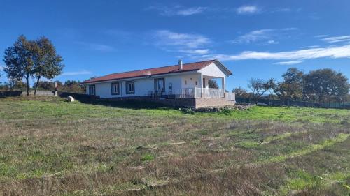 a house on a hill in a field at “Casa abella “ in La Magdalena