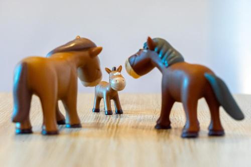 a group of plastic toy horses on a table at Landhaus Familie Allgeier in Holtgast