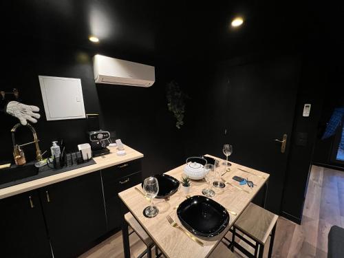une cuisine avec une table avec des verres à vin dessus dans l'établissement Le Chat Hyper Centre Dole, à Dole