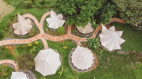 an aerial view of a park with white umbrellas at Eco Luxe Glamping Tent - 2 Queen Beds at Holos in Barú