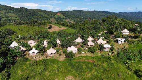 an aerial view of a group of tents on a hill at Eco Luxe Glamping Tent - 2 Queen Beds at Holos in Barú