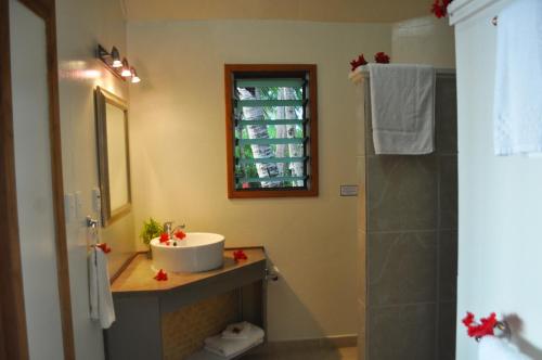 a bathroom with a sink and a shower at Le Vasa Resort in Fuailalo